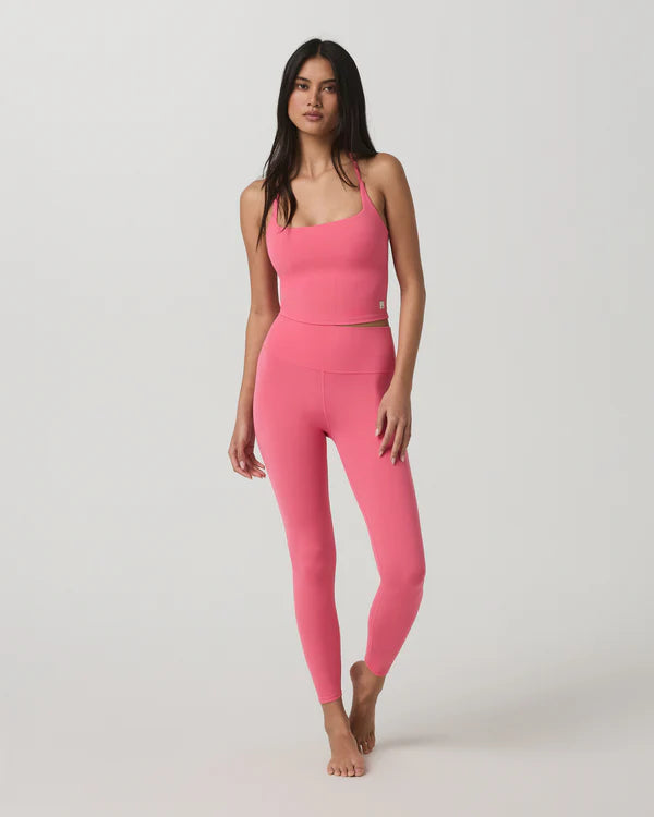Woman wearing a Vuori - AllTheFeels™ Legging in Sunset Pink on a white background