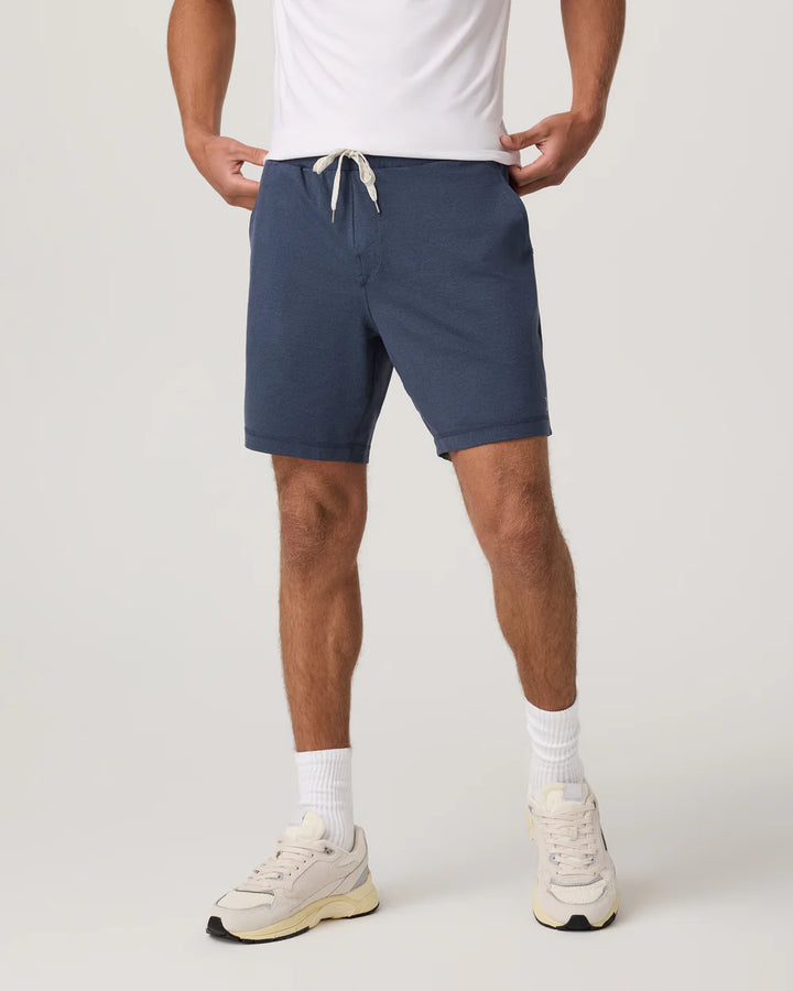 Person wearing Vuori - Ponto navy shorts on a plain background