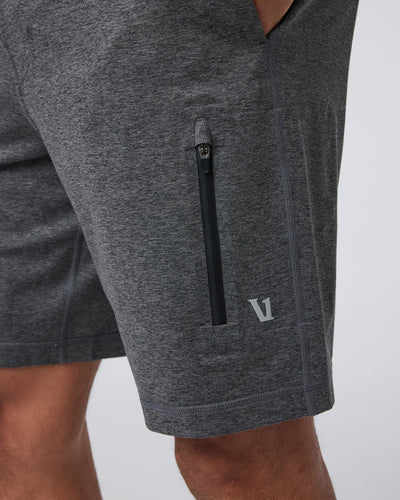 Charcoal Vuori - Sunday Performance Short 8" shorts with a zipper pocket on a light gray background