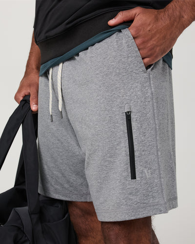 Gray Vuori - Sunday Performance Short 8" with a black zipper pocket and drawstring on a neutral background